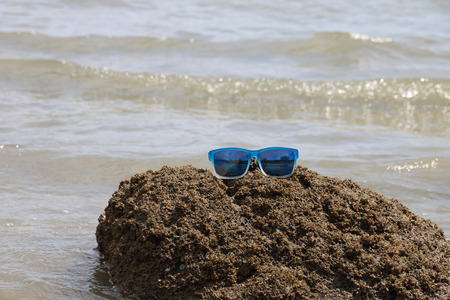 sunglasses on the stone seasideの写真素材