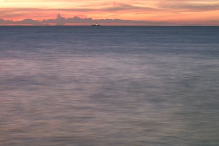 Long exposure photo of the beach dramatic in the eveningの写真素材