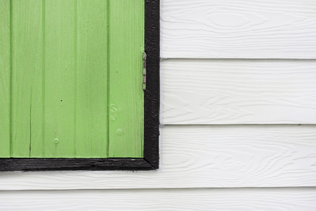 Corner of a green wood window on white wood wall in a house.の写真素材