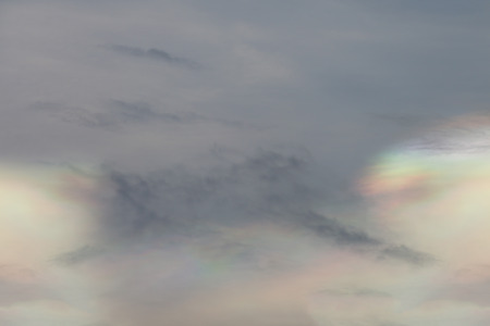 Cloud iridescence phenomenon on sunset sky.の写真素材