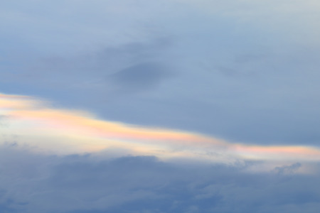 Cloud iridescence phenomenon on sunset sky.の写真素材