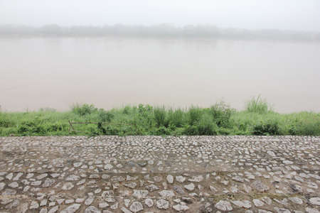 Stone staircase at riverside covered by mist.の写真素材