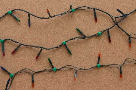 Christmas lights on wooden background.