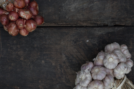 Onion and garlic on old wooden floor.の写真素材