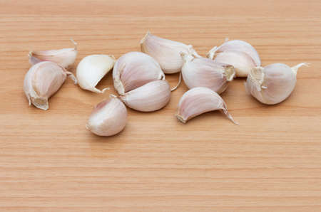 Garlic on brown wooden table.