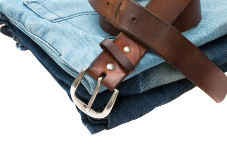 leather belt on blue jeans isolated white background.