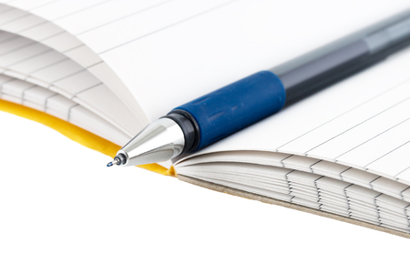 Closeup pen on notebook isolated on white background.の写真素材