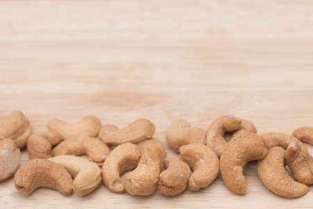 Cashew nuts on wooden cutting board.の写真素材