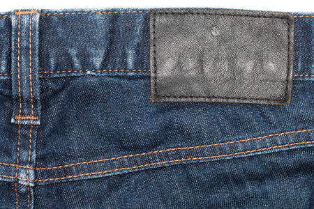 Denim Closeup : texture background of leather label on blue jeans.の写真素材