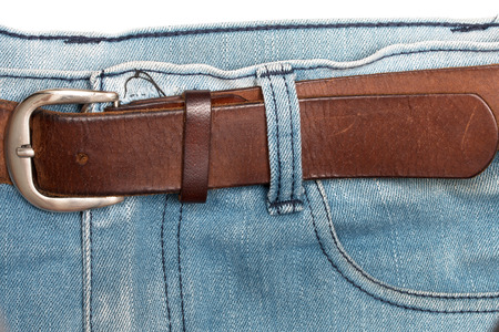 Old brown belt with blue jeans.の写真素材