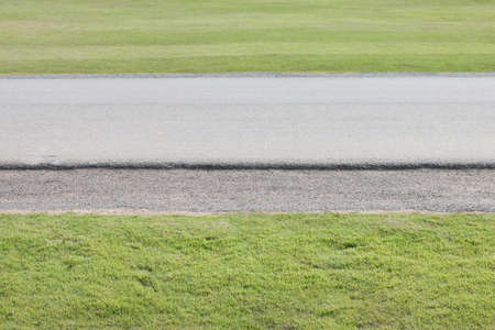 road between green grass.の写真素材