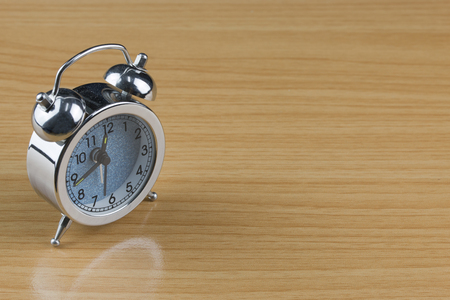 alarm clock on wood table.