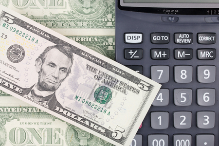 calculator and dollars bills.の写真素材