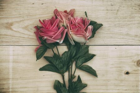 bouquet rose on wood background - vintage filtered.の写真素材