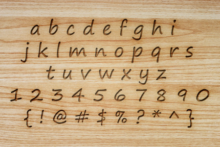 alphabet and punctuation on wood texture background.の写真素材