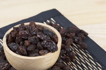 raisins in bowl on table.の写真素材