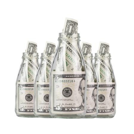 dollar bills in glass jar isolated on white backgroundの写真素材