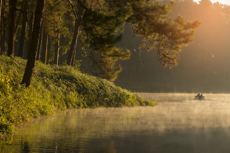 beautiful scenery - bamboo rafting through the mist on the lake in morning at Pang-ung, in Mae Hong Son,Thailandの写真素材