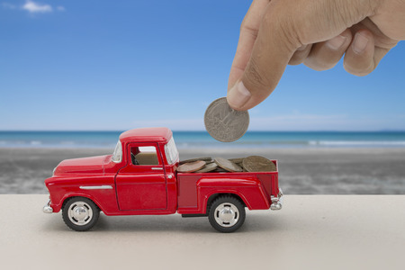 Saving money for car for cash, finance concept with tropical sea and beach backgroundの写真素材