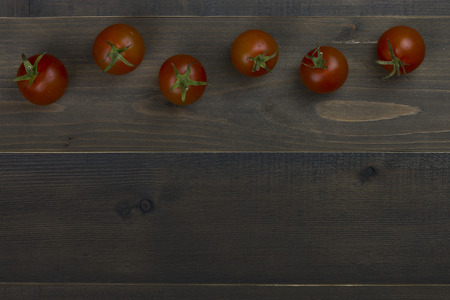 Close-up of fresh, ripe tomatoes on wood tableの写真素材