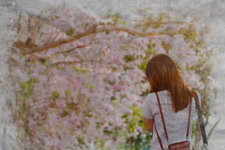 watercolor of woman standing back and look at the pink flower blossomの写真素材