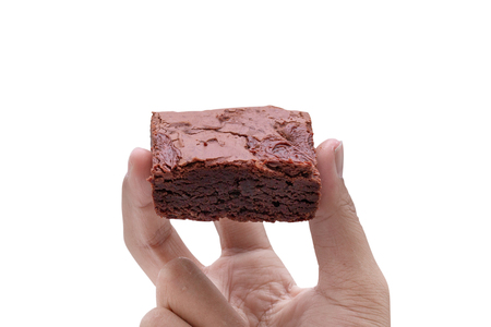 hand holding cake chocolate brownies isolated on white background - clipping pathsの写真素材