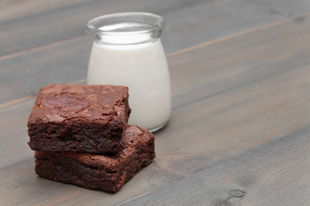 homemade cake chocolate brownies and milk on wooden tableの写真素材