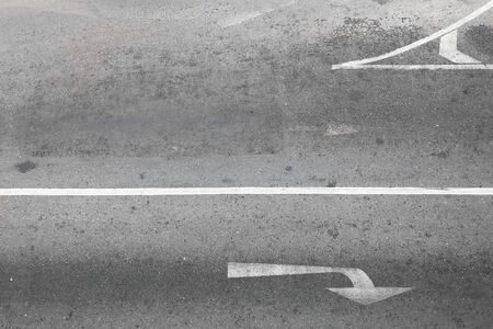 Asphalt road with turn symbol - top view.