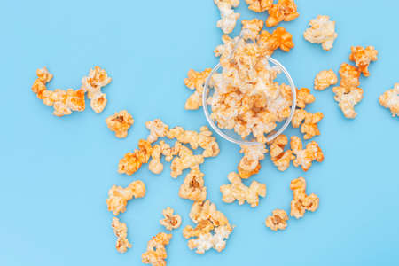 Popcorn in a bowl on blue background.の写真素材