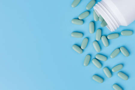 Medical pills on blue background. Top view with copy space.の写真素材