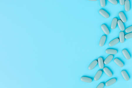 Medical pills on blue background. Top view with copy space.の写真素材