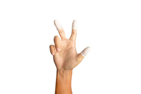 Finger cots is on the fingers to help prevent fingerprints on the finger touched piece. clipping paths.の写真素材