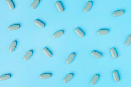 Medical pills on blue background. Top view with copy space.の写真素材