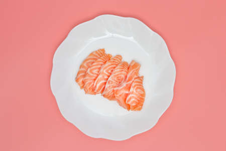 salmon on dish on pink background.の写真素材