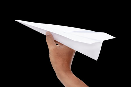paper plane in hand isolated on black backgroundの写真素材