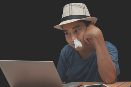 The young man watching adult videos on a laptop, aroused and excited addict man addiction and...