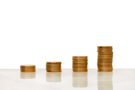 Stack of a coin showing increase graph isolated on white background.