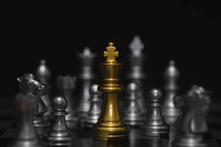 Shot of chessboard golden king battle. Concept for strategy, business victory.の写真素材