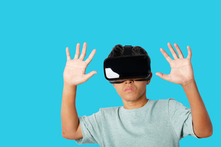 Young man using virtual reality headset. VR, future, technology online concept. isolated on blue background. clipping paths.の写真素材