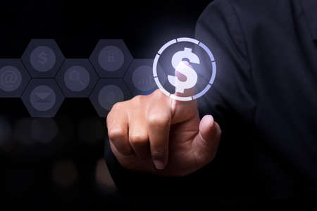 Businessman touching money currency icon with finger. concept about global finance.の写真素材