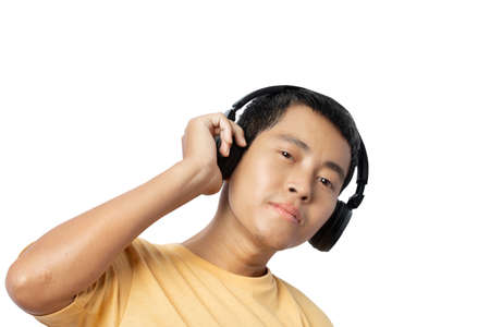 Young man listening music with headphones isolated on white background. clipping paths.の写真素材
