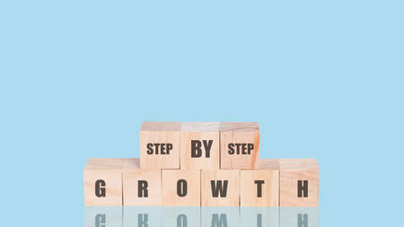 Arranging wood cube with text of step by step and growth. Business concept growth success process....