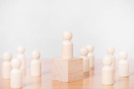 Wood person model standing on the podium among people on white background.の写真素材