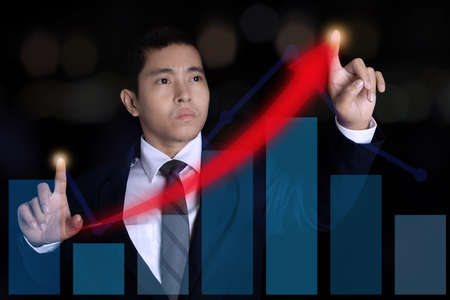 Businessman pointing spot on the graph finance chart. Digital business hologram graph finance chart...