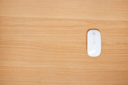 wireless mouse for computer and laptop on wood background. top view. copy space.の写真素材