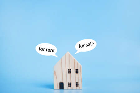 House model for rent and for sale on blue background. Family home, Insurance and property investment...