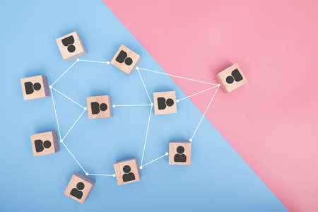 Wooden blocks connected together on pink and blue background. Cooperation, teamwork, network and community concept.の写真素材