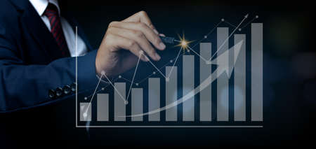 Businessman pointing spot on the graph finance chart. Digital business hologram graph finance chart...