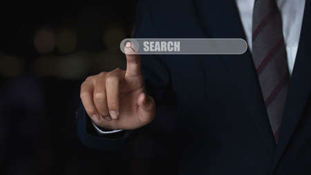 Business man touching magnifying glass icon search. Searching information data networking concept.の写真素材