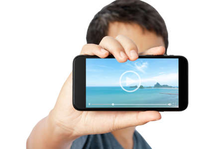 Young man showing video of beautiful beach by mobile phone isolated on white background. clipping...